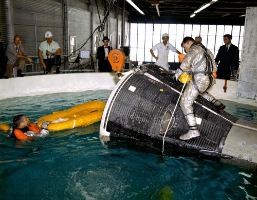 Pictured during an emergency egress training session, Young (right) and Grissom (in water) illustrate the smallness of the Gemini capsule. Grissom's ability to fit snugly inside its cabin led to the nickname 'Gusmobile'. Photo Credit: NASA