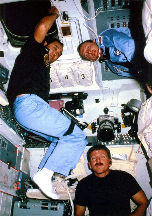 In one of relatively few images ever publicly released from Mission 51C, astronauts Loren Shriver (bottom), Ellison Onizuka (left) and Jim Buchli pose for a photograph in Discovery's flight deck. Photo Credit: NASA