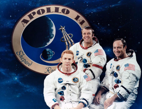 The Apollo 14 crew, from left, consisted of Stu Roosa, Al Shepard and Ed Mitchell. They are backdropped by their official mission patch. Photo Credit: NASA