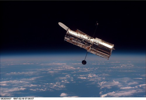 Ready to resume its mission of exploration, a rejuvenated Hubble drifts away into the inky blackness after deployment. Photo Credit: NASA