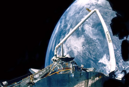 Completely filling the shuttle's payload bay, the Hubble Space Telescope glistens in the incessant glare of orbital daytime, shortly after arrival in space. Photo Credit: NASA