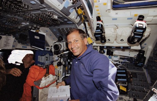 As Jim Newman (left) eyeballs one of STS-69's two satellite payloads through the flight deck windows, Ken Cockrell takes a moment to grin for the camera. Photo Credit: NASA