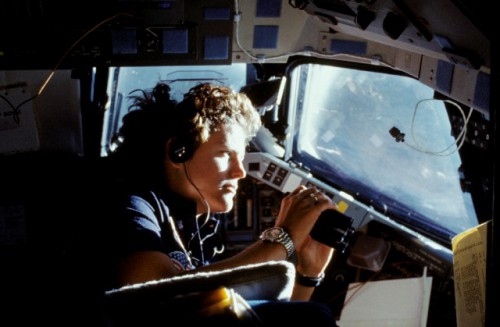 Kathy Sullivan peers through Challenger's flight deck windows during the mission. Photo Credit: NASA