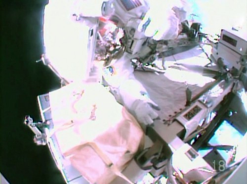 Barry "Butch" Wilmore's helmet camera captured this perspective of crewmate Reid Wiseman tending to the SSU replacement task. Photo Credit: NASA