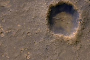 The High Resolution Imaging Science Experiment (HiRISE) camera on NASA's Mars Reconnaissance Orbiter recorded this view on Jan. 29, 2012, providing the first image from orbit to show Spirit's lander platform in color. The view covers an area about 2,000 feet (about 600 meters) wide, dominated by Bonneveille Crater. North is up. A bright spot on the northern edge of Bonneville Crater is a remnant of Spirit's heat shield. Image Credit: NASA/JPL-Caltech/Univ. of Arizona