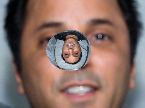 NASA astronaut Joe Acaba, Expedition 31 flight engineer, watches a water bubble float freely between him and the camera, showing his image refracted, on the International Space Station. Credit: NASA