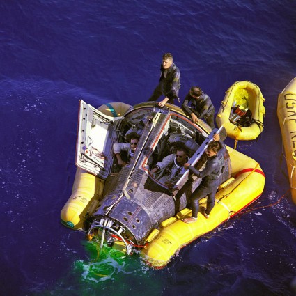 Astronauts Dave Scott (left) and Neil Armstrong breathe the fresh air of the western Pacific after splashdown. In addition to their traumatic voyage, both men had also suffered severe seasickness. Photo Credit: NASA