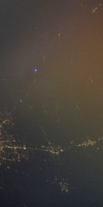 A bright flashing light (upper center of image) used to signal the ISS north of San Antonio was successfully caught & photographed for the first time on March 3. Photo Credit: NASA/Don Pettit
