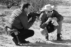 Pictured in January 1970, astronauts Jim Lovell (left) and Fred Haise perform a geological training exercise in the Quitman Mountains of far-western Texas. As Haise describes the specimen, Lovell photographs it. Photo Credit: NASA