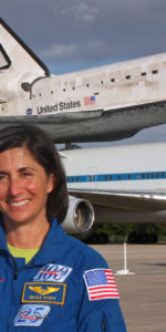 NASA astronaut Nicole Stott poses for a photo in front of space shuttle Discovery. Nicole flew as a mission specialist on Discovery last mission, STS-133, and will be at Kennedy Space Center to see the orbiter off on its final flight April 17th; a one-way trip from KSC to the Smithsonian National Air and Space Museum. Photo Credit: Mike Killian