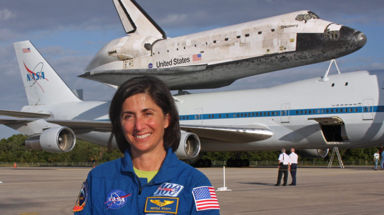 NASA astronaut Nicole Stott poses for a photo in front of space shuttle Discovery. Nicole flew as a mission specialist on Discovery last mission, STS-133, and will be at Kennedy Space Center to see the orbiter off on its final flight April 17th; a one-way trip from KSC to the Smithsonian National Air and Space Museum. Photo Credit: Mike Killian