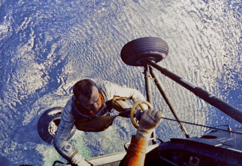 Astronaut Al Shepard is winched to the recovery helicopter, minutes after splashdown from America's first piloted Mercury flight. Photo Credit: NASA