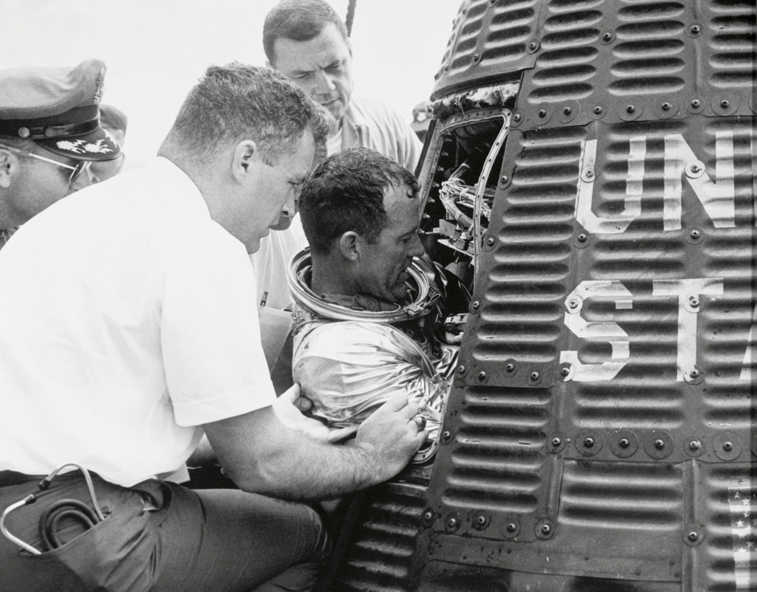 Gordon Cooper is extracted from the Faith 7 capsule, on the deck of the USS Kearsarge on 16 May 1963. The astronaut's 34-hour, 22-orbit mission proved as colorful as Cooper himself. Photo Credit: NASA