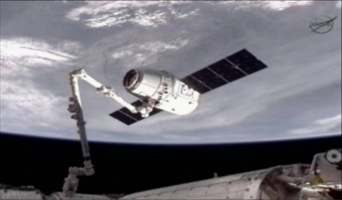 The Dragon spacecraft will be captured and berthed by means of the space station's Canadarm2 robotic arm. Photo Credit: NASA TV