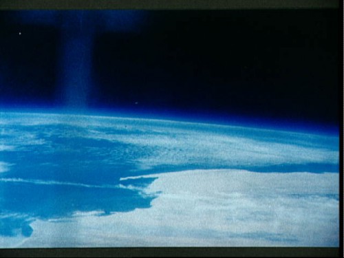The stunning grandeur of a cloud-bedecked Earth, viewed by Scott Carpenter and his hand-held camera. Photo Credit: NASA