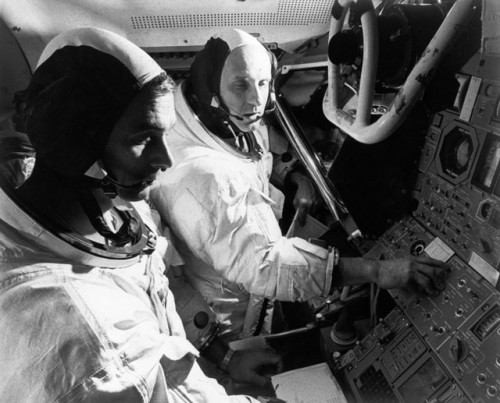Six weeks before launch, Gene Cernan (left) and Tom Stafford stand side by side at the controls of the lunar module simulator. Their mission into the unknown would bring humanity closer to the Moon than had ever been achieved in history...until the landing itself on Apollo 11. Photo Credit: NASA