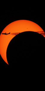 What appears to be a 747 airliner passing through the crescent eclipsed sun. Photo Credit: Mike Killian / ARES Institute and AmericaSpace