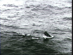 Although Carpenter's heartbeat had been clearly heard in Mission Control throughout re-entry, the public at large had no idea if the astronaut had survived his perilous descent. Here, Aurora 7 and Carpenter are readied for winching out of the water. Photo Credit: NASA