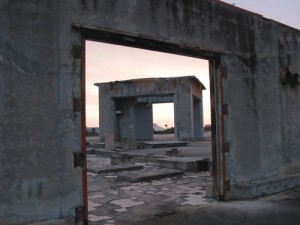 Haunting view of the deserted Pad 34 site, seen through the doorway of what was once the blockhouse. Here, on 27 January 1967, America's goal of reaching the Moon was placed in jeopardy in the most tragic way. Photo Credit: NASA