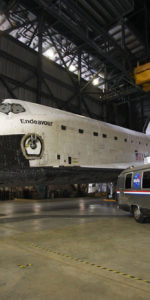 Endeavour inside NASA's Vehicle Assembly Building at Kennedy Space Center, displayed with the Astrovan which brought astronauts to the launch pad for their missions. Photo Credit: Mike Killian / Zero-G News and AmericaSpace