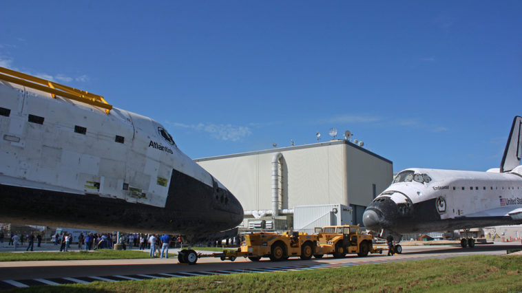 Space shuttle's Atlantis and Endeavour, face-to-face for the last time as they swaped locations at Kennedy Space Center this morning. Atlantis was moved back to the OPF to finish out her retirement processing, and Endeavour was moved into the VAB to await her flight to California next month. Photo Credit: Mike Killian for Zero-G News and AmericaSpace