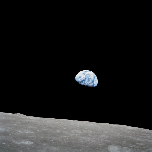 In a view never seen by human eyes before Christmas Eve 1968, the distant Earth rises above the lunar limb. Photo Credit: NASA