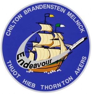 Proudly demonstrative of her nautical and exploratory heritage through Captain James Cook's vessel, and bearing the colors of the elementary and secondary schools which named her, Endeavour's first patch is bordered by the names of her first seven astronauts: Commander Dan Brandenstein, Pilot Kevin Chilton and Mission Specialists Rick Hieb, Bruce Melnick, Pierre Thuot, Kathy "K.T." Thornton and Tom Akers. Image Credit: NASA 