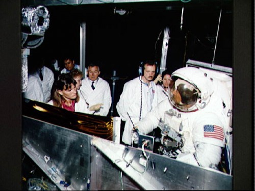 A fully-suited Story Musgrave prepares for a vacuum chamber test in May 1993, watched by fellow STS-61 astronauts Tom Akers and Kathy Thornton. Only days after this photograph was taken, Musgrave suffered severe frostbite in his fingers. Photo Credit: NASA