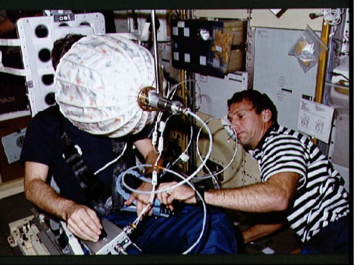 Pictured during a visual acuity test with Ulf Merbold, astronaut Dave Hilmers (right) was added to the STS-42 crew only nine months before launch. Photo Credit: NASA