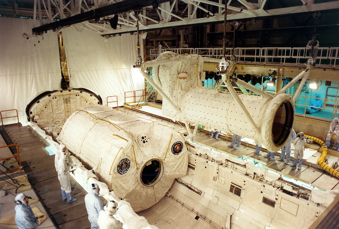The tunnel adaptor for the IML-1 Spacelab module is prepared for installation in the Orbiter Processing Facility. STS-42 was the first human launch of International Space Year 1992. Photo Credit: NASA