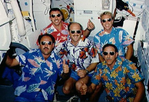 Clad in Hawaiian shirts, the 'Loud and Proud' STS-26 crew take a few light moments for a photograph on Discovery's middeck, late in the mission. Rick Hauck is flanked by (clockwise from top-right) George 'Pinky' Nelson, Dick Covey, Mike Lounge and Dave Hilmers. Photo Credit: NASA