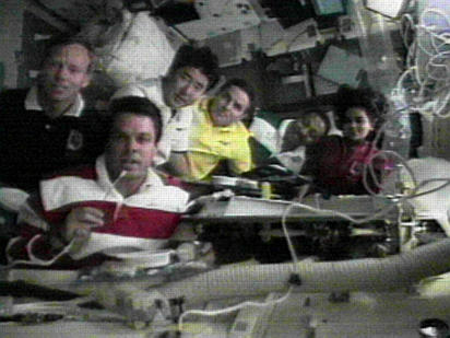 During STS-87 in November 1997, Commander Kevin Kregel (left, with microphone) spoke directly to President Bill Clinton to receive and extend Thanksgiving wishes. Kregel told the president that although they missed their families on Earth, their relationship as a crew had turned them into a family unit. Photo Credit: NASA