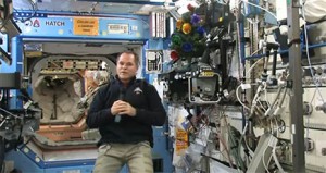 With a small Christmas tree in attendance, Expedition 34 Commander Kevin Ford sends his season's greetings to an Earthbound audience last week. Photo Credit: NASA