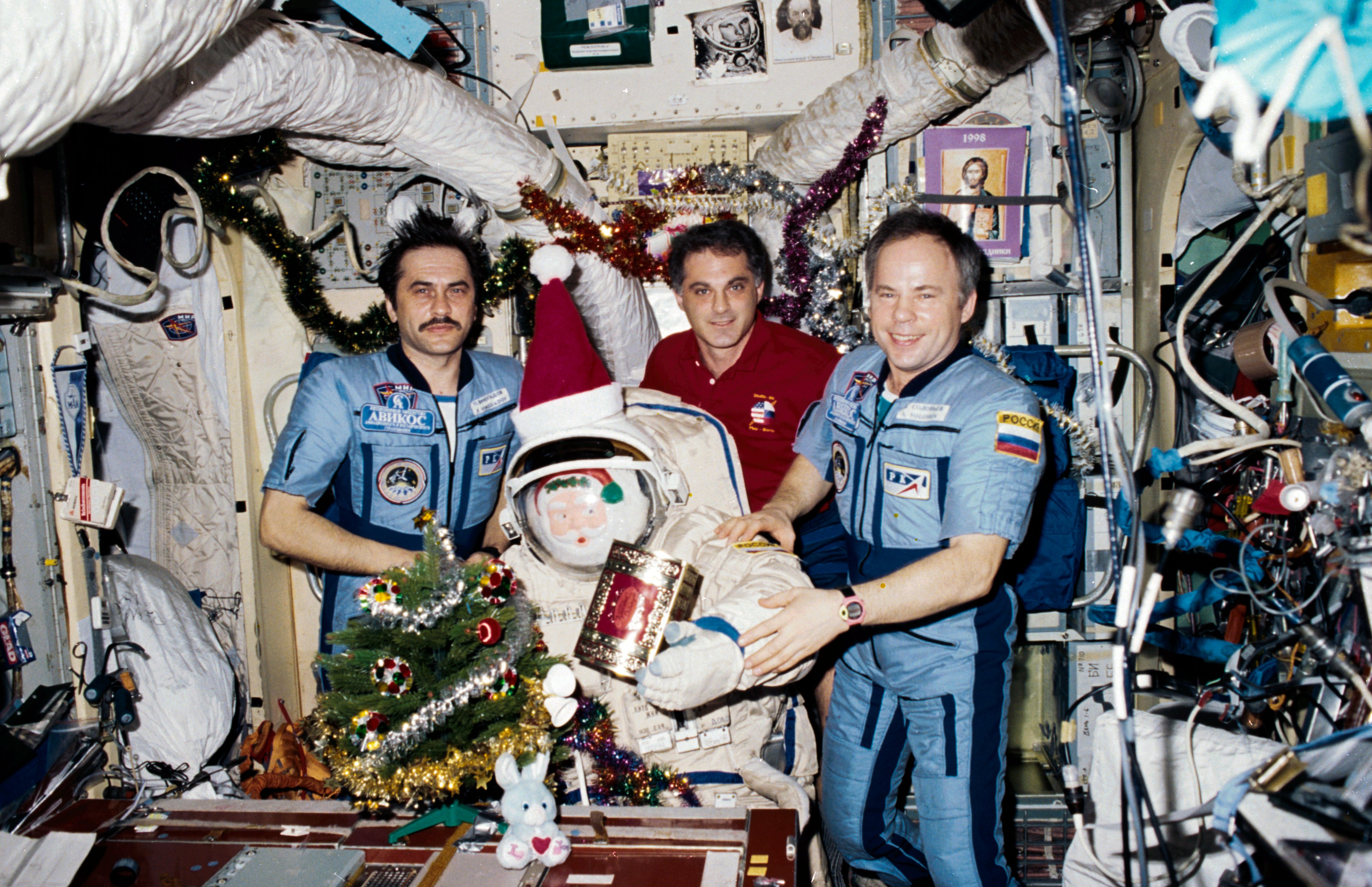 Dave Wolf (center) was the second and last American astronaut to celebrate Christmas aboard Russia's Mir space station in 1997. He spent the festive period alongside cosmonauts Anatoli Solovyov (right) and Pavel Vinogradov. Photo Credit: NASA