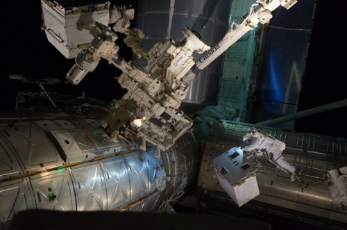 In this NASA photo, spacewalkers Mike Fossum and Ron Garan deliver the Robotic Refueling Mission from Atlantis’ payload bay to a temporary platform on the International Space Station’s Dextre robot. Photo Credit: NASA