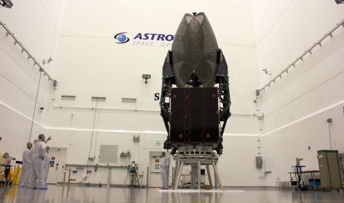 Looking like an enormous black insect, the TDRS-K satellite undergoes final checkout in Astrotech's payload processing facility, near the Kennedy Space Center. Photo Credit: Jason Rhian