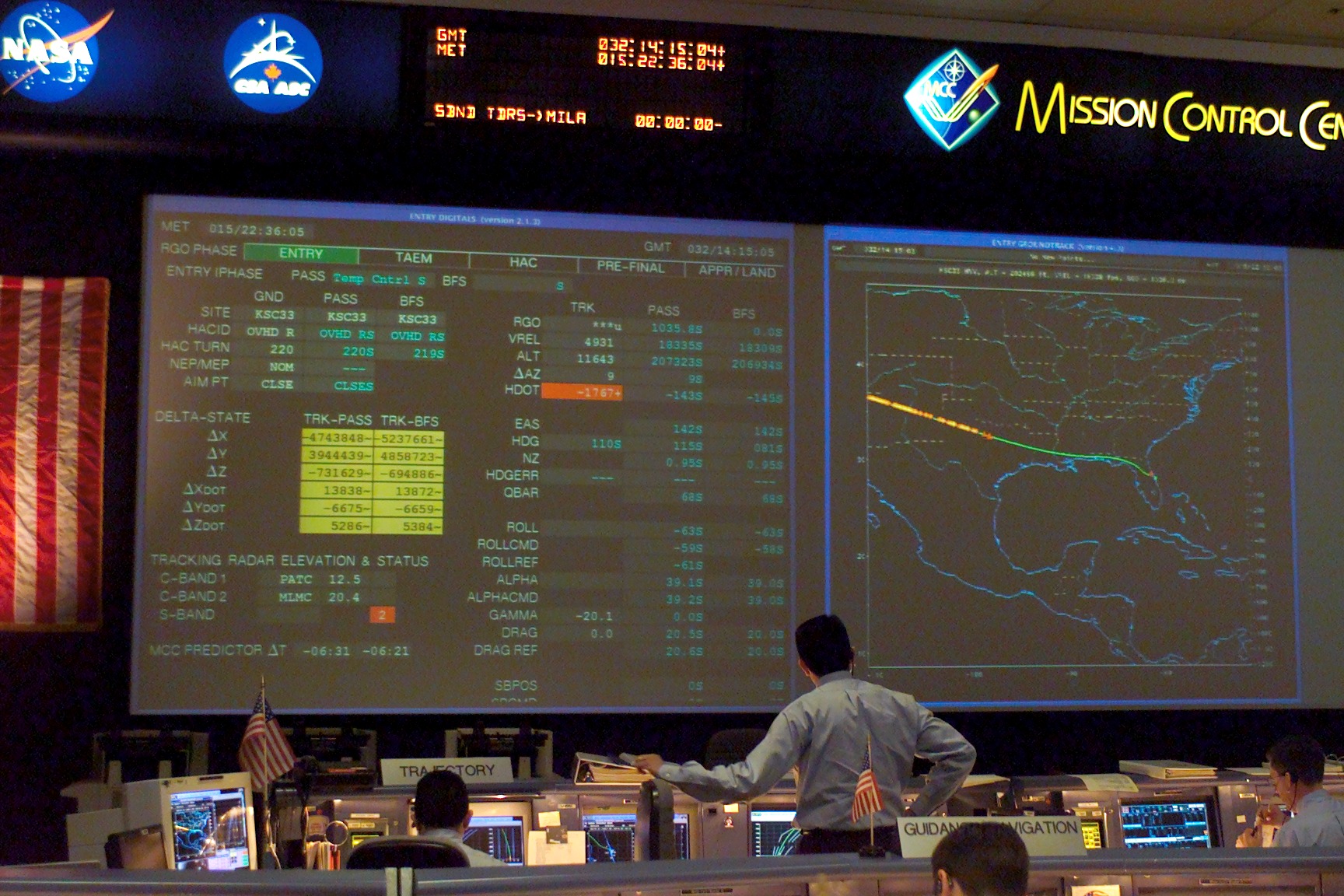 As evidenced by the clock on the main screen at 14:15:05 GMT (9:15:05 am EST), this view of a tense Mission Control was acquired a quarter of an hour after the first sign of trouble...and a minute ahead of Columbia's expected landing. By now, everyone was aware that all hope was gone and contingency procedures were in effect. Photo Credit: NASA