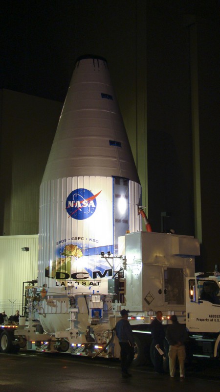 Encapsulated within its payload fairing, the Landsat Data Continuity Mission (LDCM) spacecraft is prepared for transfer to SLC-3 at Vandenberg Air Force Base on 25 January 2013. Photo Credit: NASA