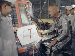 John Glenn looks approvingly at Cecelia Bibby's hand-crafted script for his Mercury capsule. Photo Credit: NASA