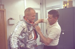 Suit technician Al Rochford assists John Glenn with his silver ensemble, as America's first orbital mission draws closer. Photo Credit: NASA
