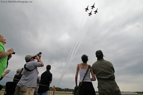 Spectators at the 2013 TICO Warbird Air Show react with awe as the world-renowned Thunderbirds thunder past overhead. Photo Credit: Mike Killian / Zero G News