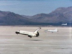 Flanked by two NASA T-38 jets, flying chase, Columbia touches down in the mountain-ringed expanse of White Sands Missile Range on 30 March 1982. Photo Credit: NASA