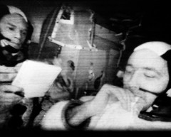 Jim McDivitt (right) and Rusty Schweickart demonstrate the smallness of the lunar module's cabin in this telecast from Spider. Photo Credit: NASA
