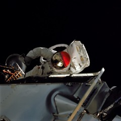 Balanced on the Lunar Module porch - with one of the footpads visible 'below' him - Rusty Schweickart puts the lunar suit through its paces. Photo Credit: NASA