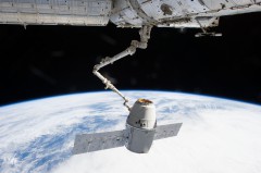 The CRS-2 Dragon is grasped by the space station's Canadarm2 robotic arm, ahead of berthing on 3 March 2013. Photo Credit: NASA