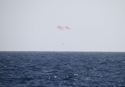 SpaceX's CRS-2 Dragon descends beneath its three red-and-white parachutes towards a splashdown in the Pacific Ocean at 12:34 p.m. EDT (4:34 p.m. GMT) on 26 March 2013. Photo Credit: SpaceX