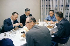 At the head of the table on launch morning, Gus Grissom looks serious ahead of becoming the first man to journey into space twice. Fellow astronaut Al Shepard (left) missed out on the command of Gemini 3, when he was struck down by an inner-ear infection. Photo Credit: NASA