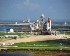 Pictured in September 1990, the problem-plagued STS-35 stack is shown in the foreground, on Pad 39A, with the STS-41 stack in the background on Pad 39B. Photo Credit: NASA