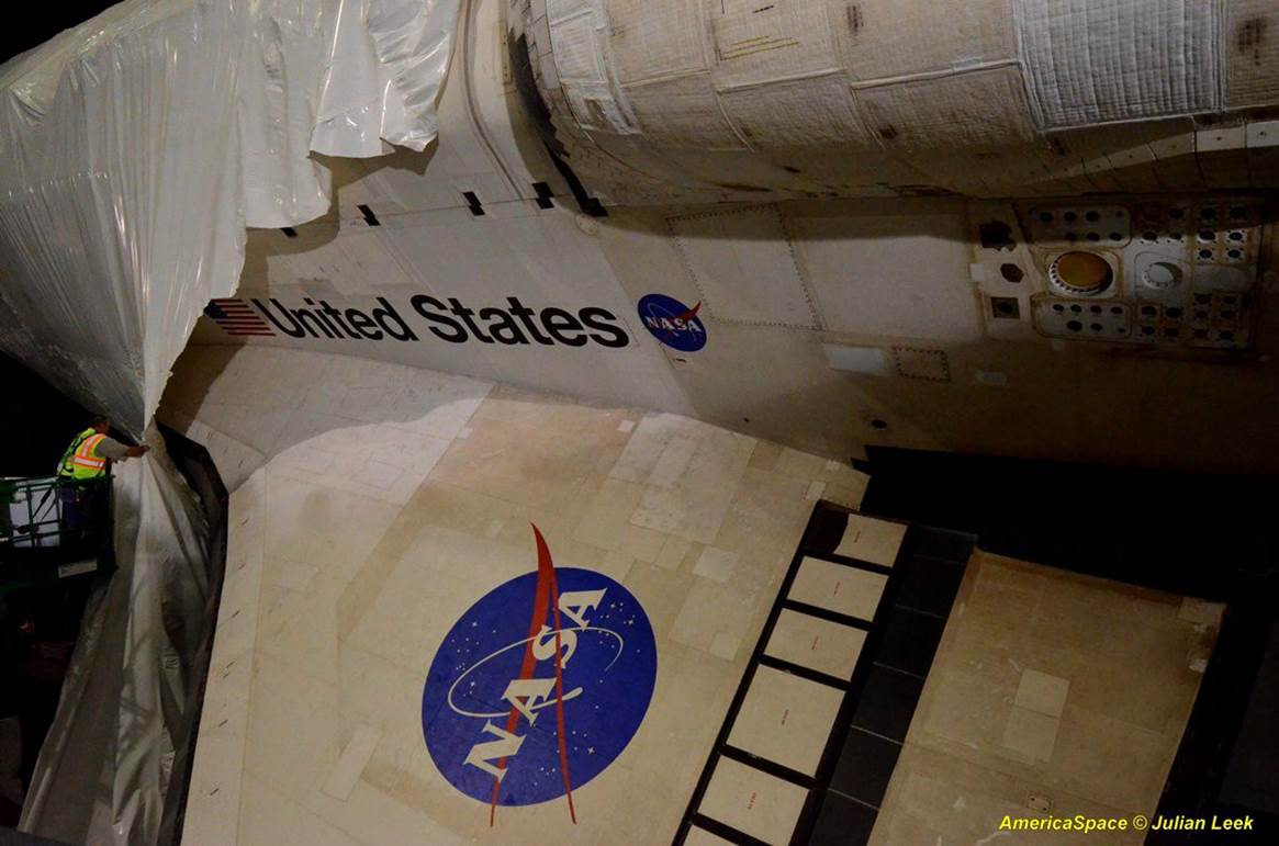 AmericaSpace image of space shuttle Atlantis’ wing emerging from
