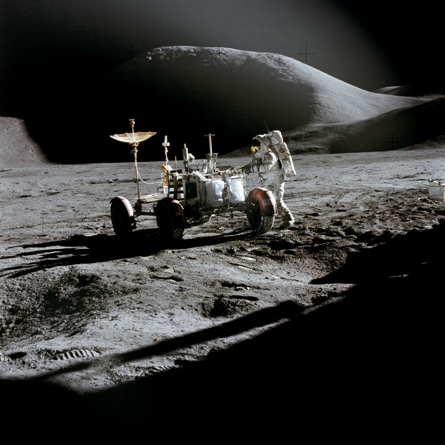 Jim Irwin works with the lunar rover, backdropped by the grandeur of Hadley, in July-August 1971. Photo Credit: NASA
